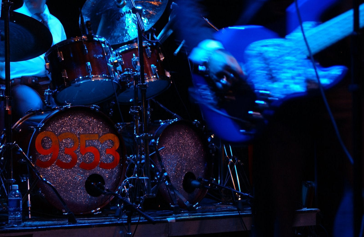 9353 performing on a blue-lit stage