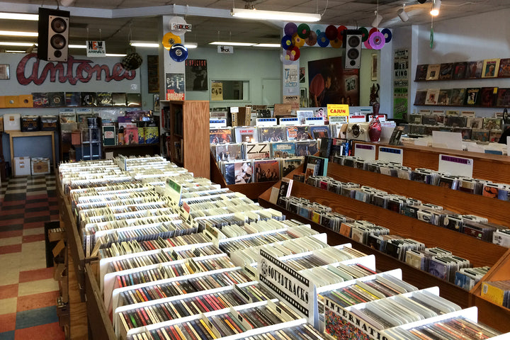 Wooden record bins and the Antone’s sign inside Antone’s Record Shop in Austin.