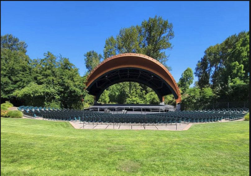 The Cuthbert Amphitheater's curved stage canopy and lawn seating in Eugene