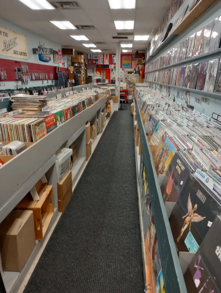 Records and CDs along an aisle at Street Corner Music.
