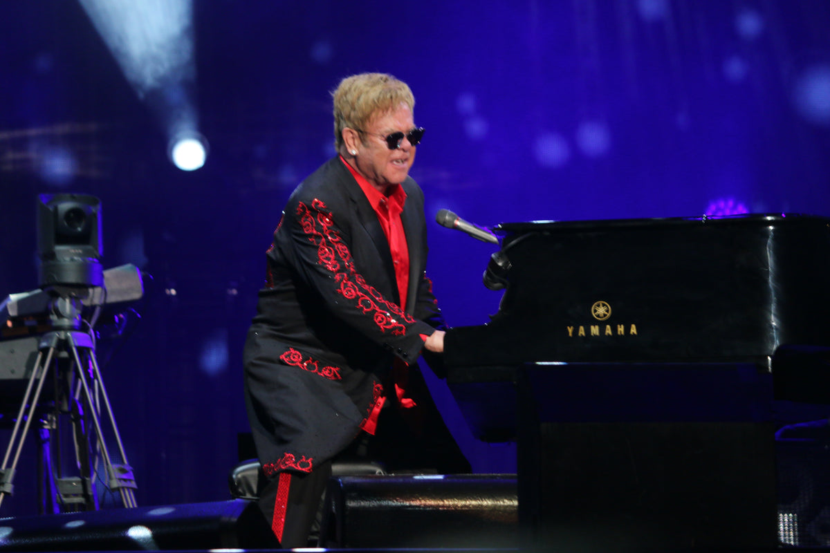 Elton John performing with his band in 2016