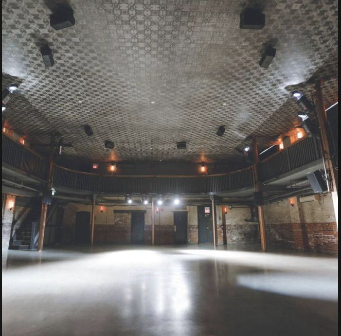 Longboat Hall's low-ceilinged performance room, stage and open floor