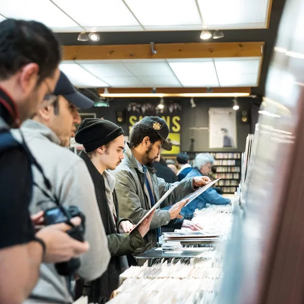 Customers browsing record bins inside Aux 33 Tours in Montréal.