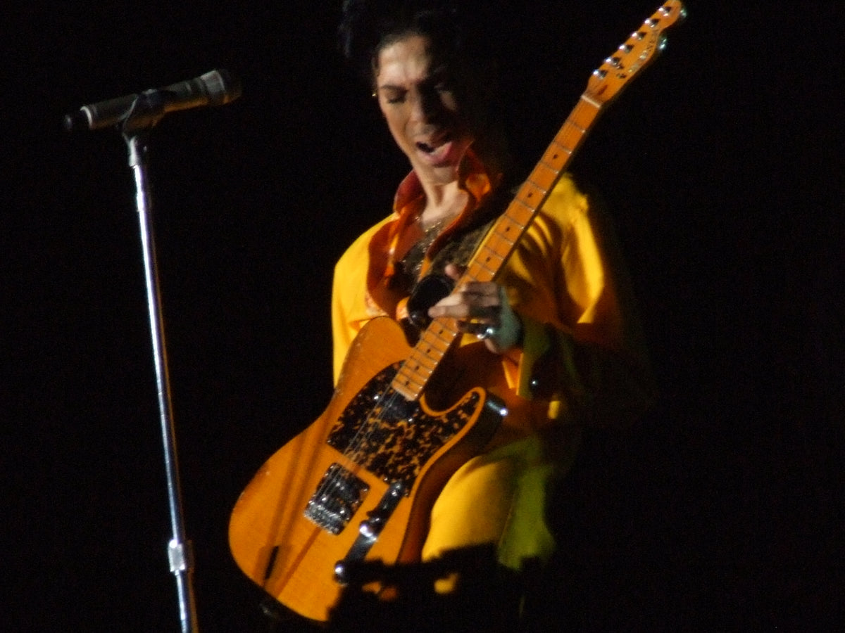 Prince playing guitar at Coachella in 2008