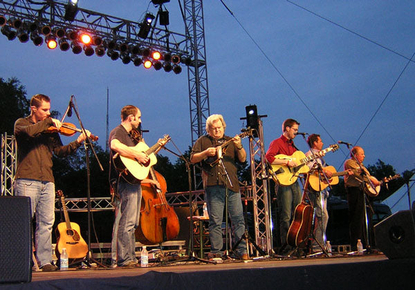 Ricky Skaggs and Kentucky Thunder performing on an outdoor stage