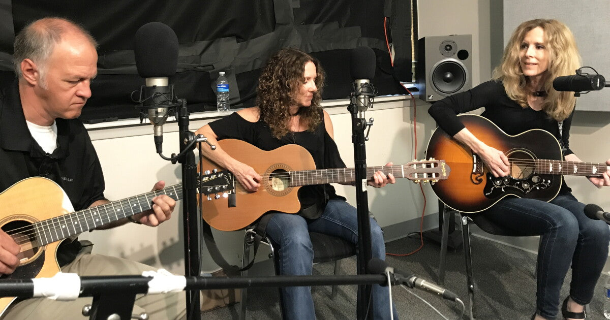 Lisa and Roberta Morales singing and playing guitars at Texas Public Radio